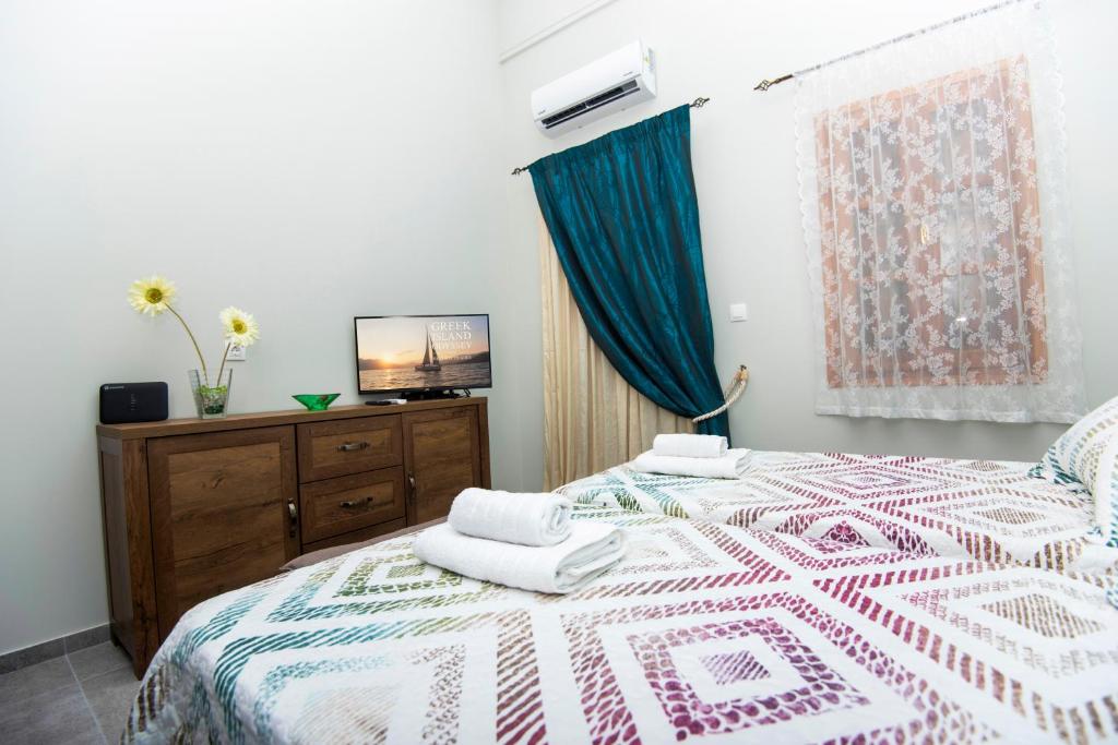 a bedroom with a bed with two towels on it at Lithos apartments in Kalymnos