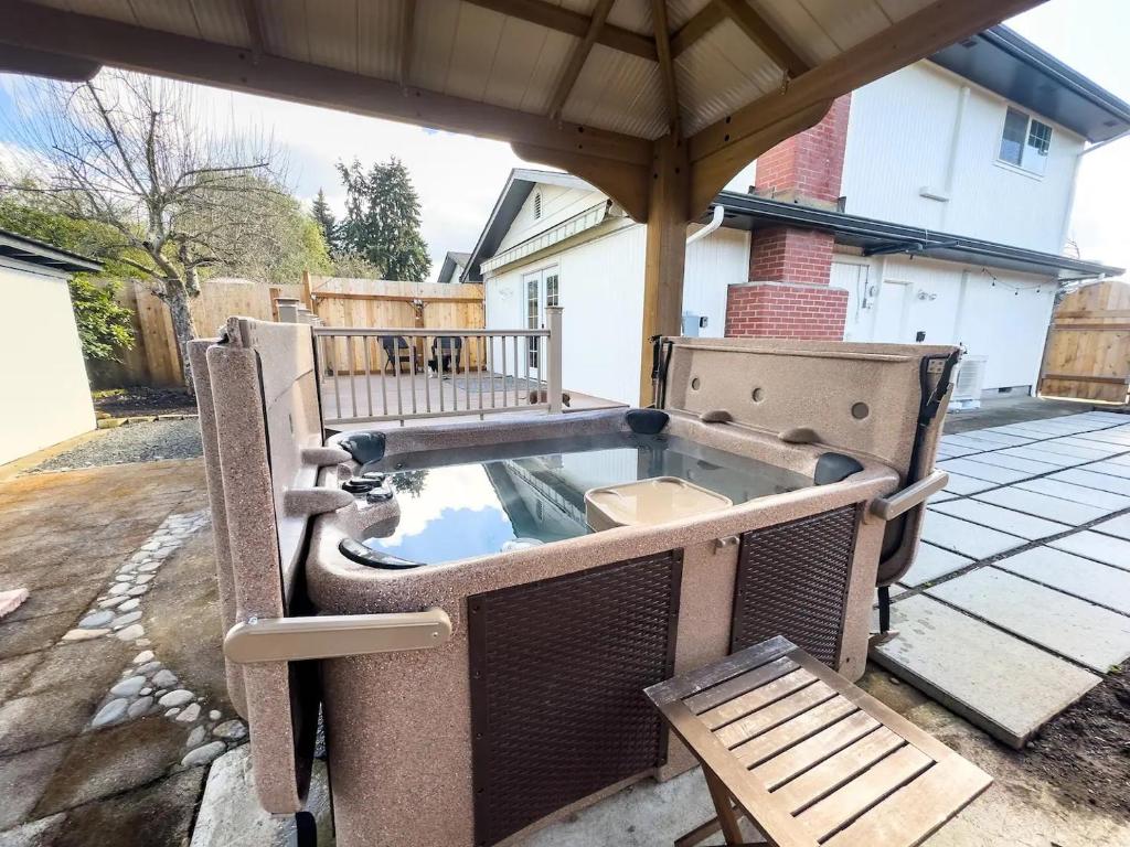 a hot tub on a patio with a bench at Northbank Loft in Springfield