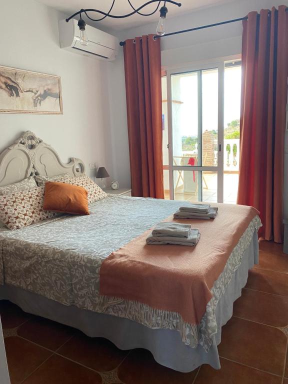 1 dormitorio con 1 cama grande y cortinas rojas en Villa Sunshine Countryside Resort en Frigiliana