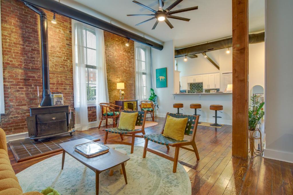 a living room with a fireplace and a brick wall at Historic Memphis Condo Walk to Beale Street! in Memphis