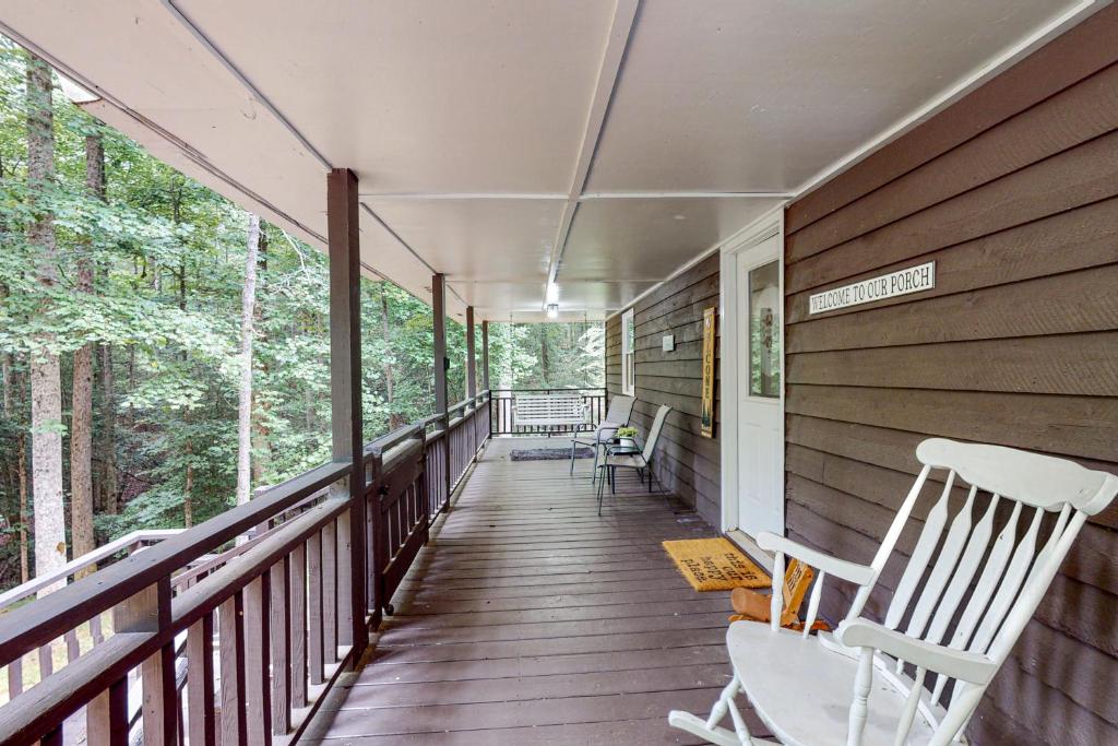 a porch of a house with rocking chairs on it at The Haggai House in Demorest