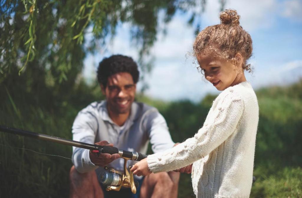 a man and a girl holding a fishing rod at Brand New Modern Holiday Home - Haven The Orchards Holiday Park in Saint Osyth