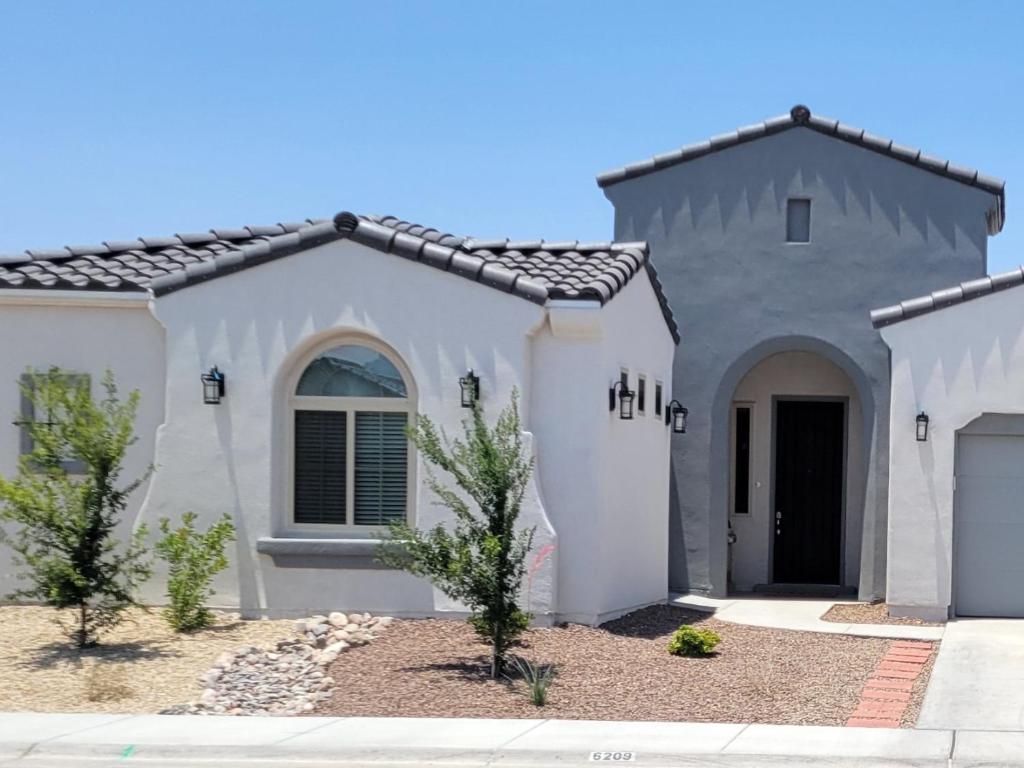 a white house with a black roof at Cozy Casita Suite in Las Cruces