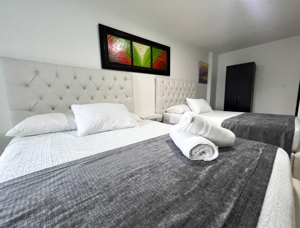 a hotel room with two beds with towels on them at Blue Emerald Inn in San Andrés