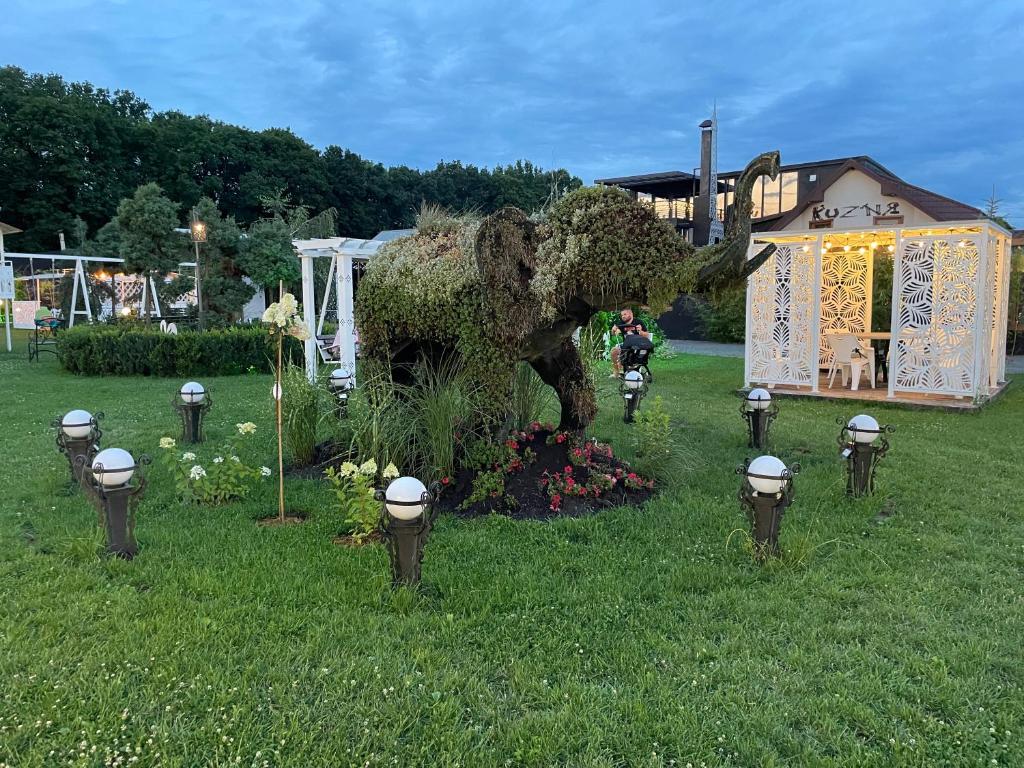 a statue of an elephant in a yard at Кузня міні-готель in Mateyevtsy