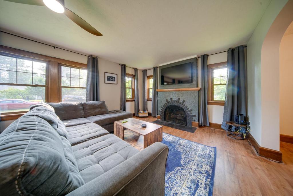 a living room with a couch and a fireplace at Central Erie Vacation Rental about 2 Mi to Beach! in Erie
