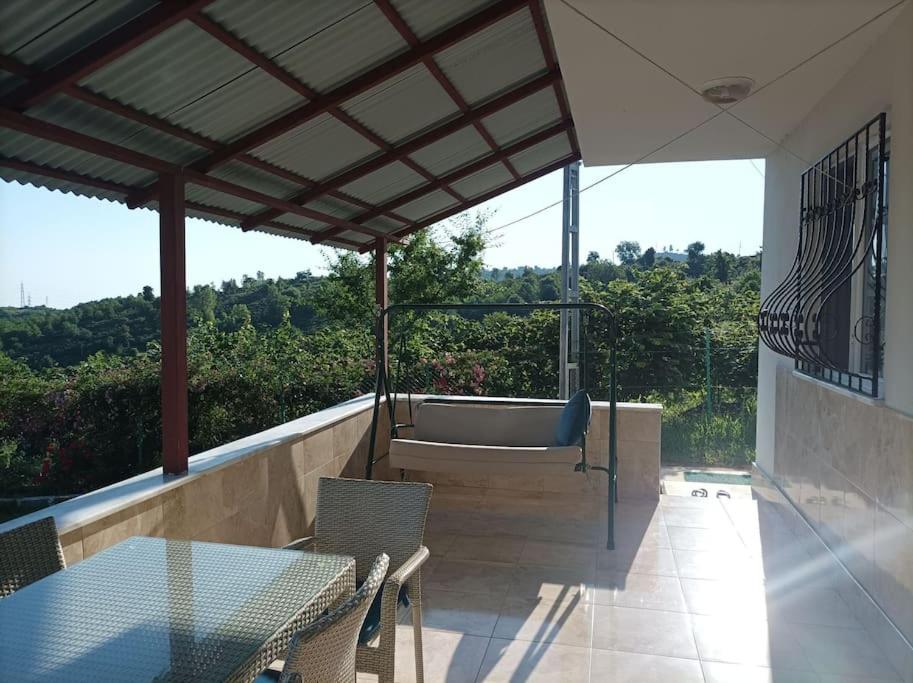 a patio with a table and chairs and a bath tub at Denize 3km Daire - Piraziz Giresun in Giresun