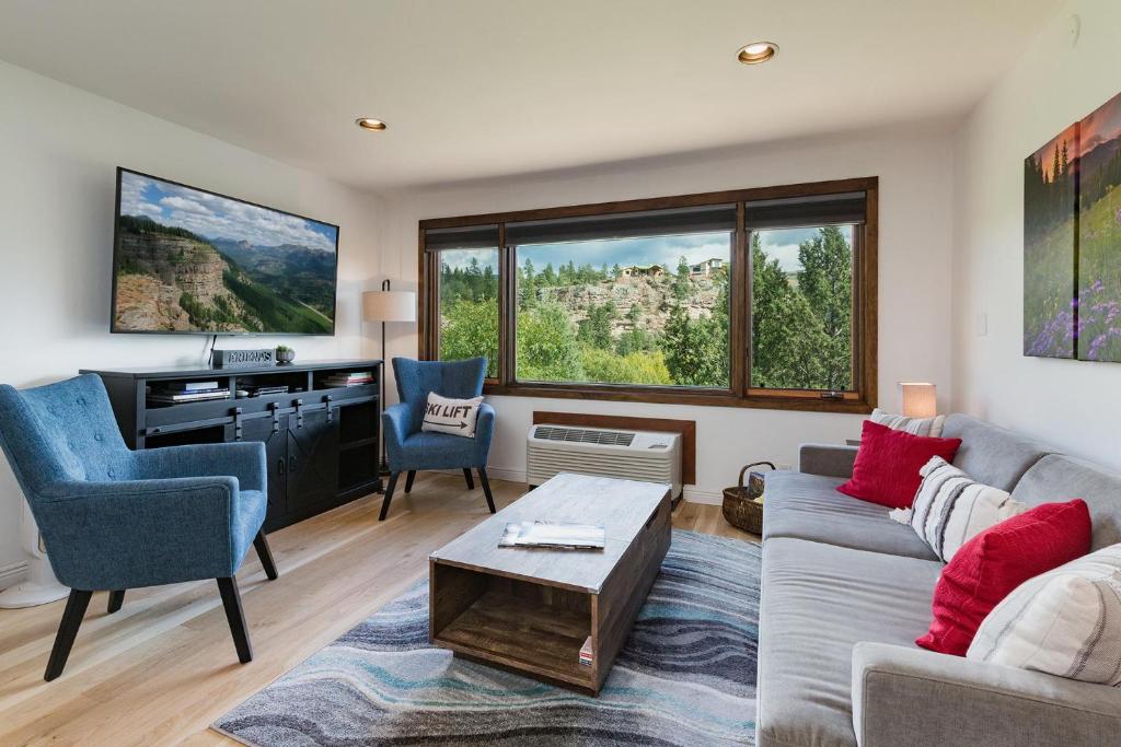 a living room with a couch and a table at Tamarron Lodge Studio - 103 in Durango