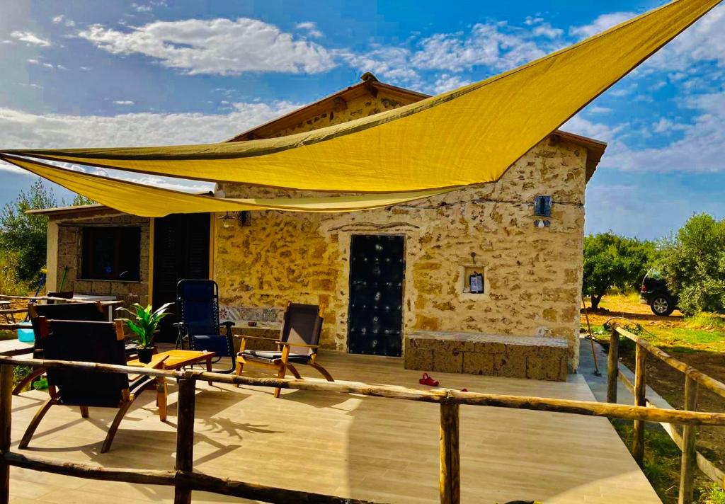 a deck with a large yellow tent on top of a house at Lovely Country House in Trappeto