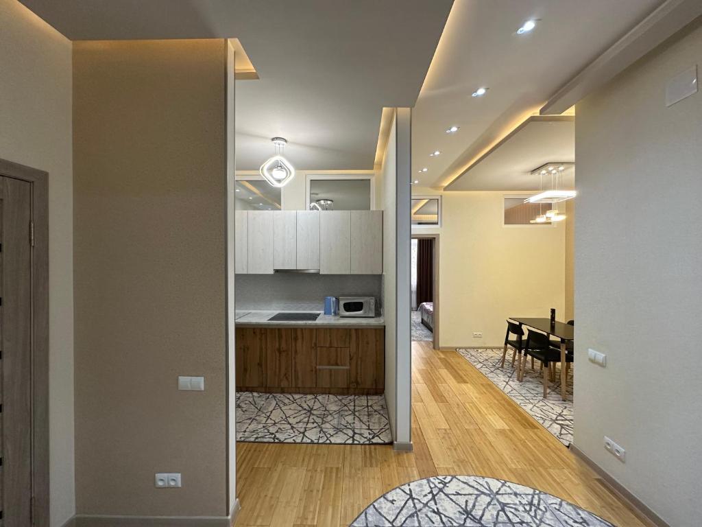 a kitchen and a dining room with a table at Dushanbe City View Apartments in Dushanbe