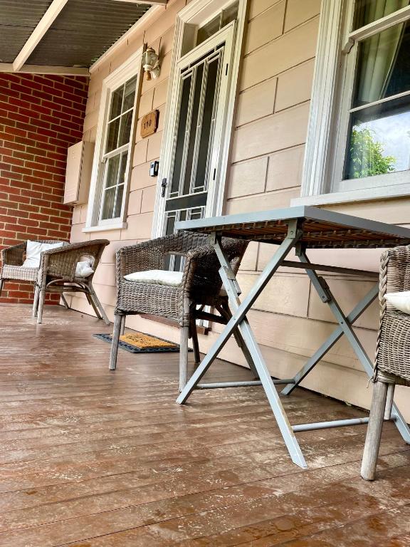 a picnic table on the porch of a house at Barnard street Cottage in Bendigo
