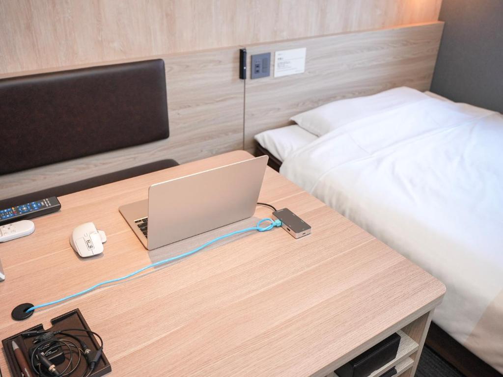 Postel nebo postele na pokoji v ubytování Super Hotel Hiroshima