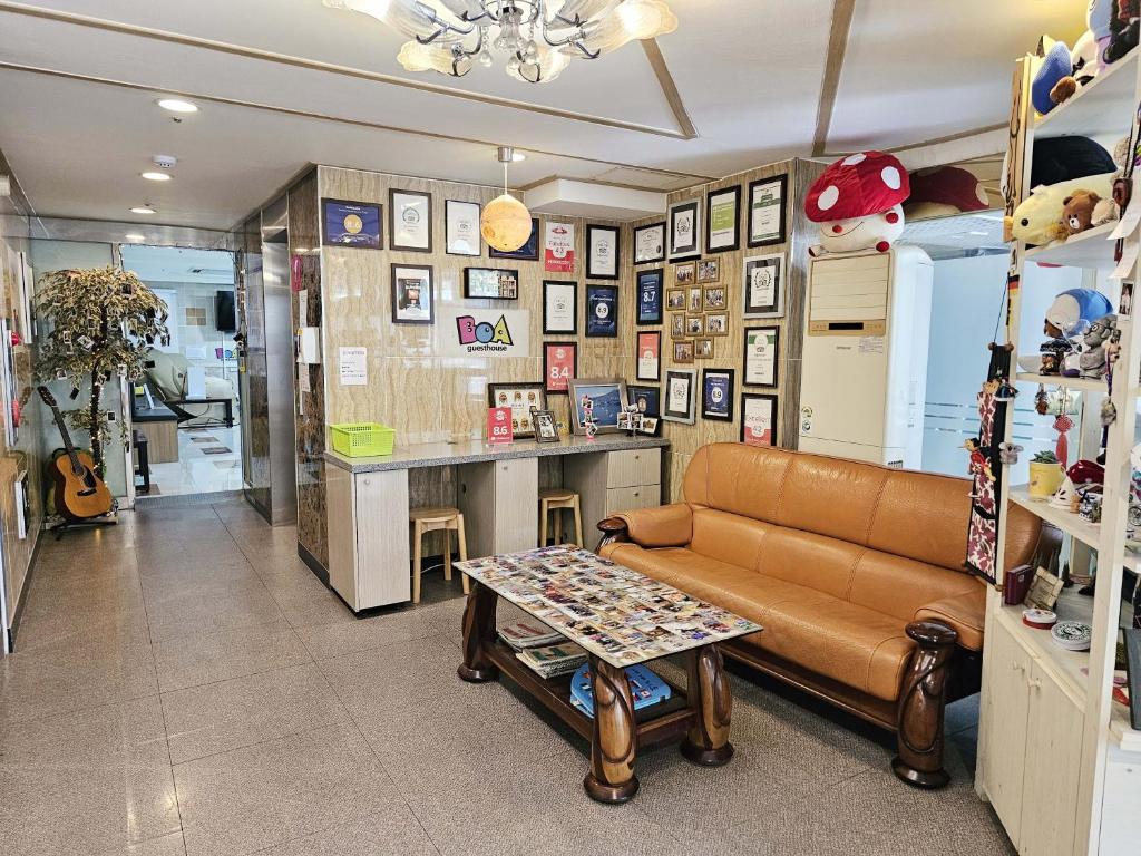 a living room with a couch and a table at BoA Travel House in Seoul