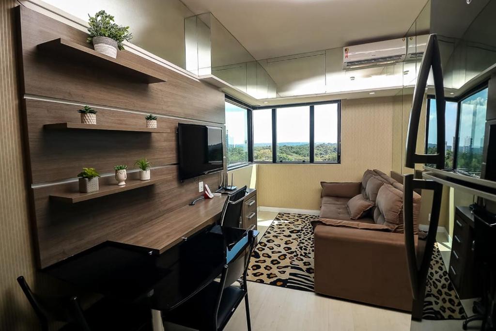 an office with a desk and a couch in a room at Tropical Executive 1006 in Manaus