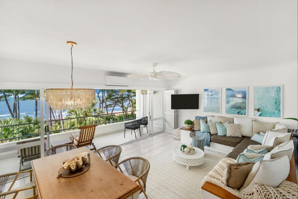 a living room with a couch and a table at Belle Escapes Suite 27 Alamanda Palm Cove in Palm Cove