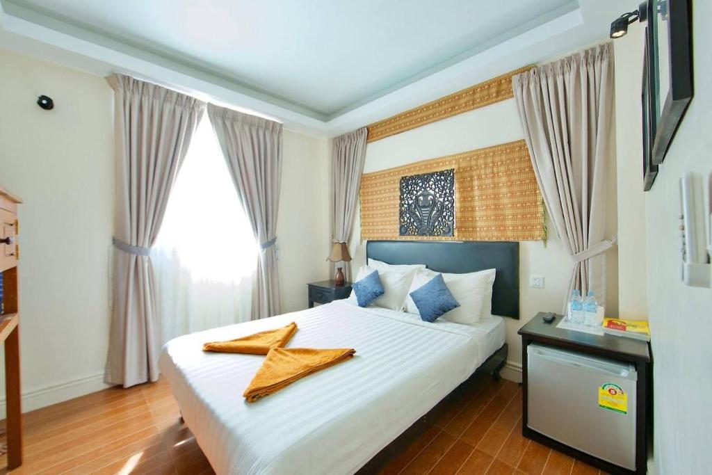 Postel nebo postele na pokoji v ubytování Naga Angkor Hostel