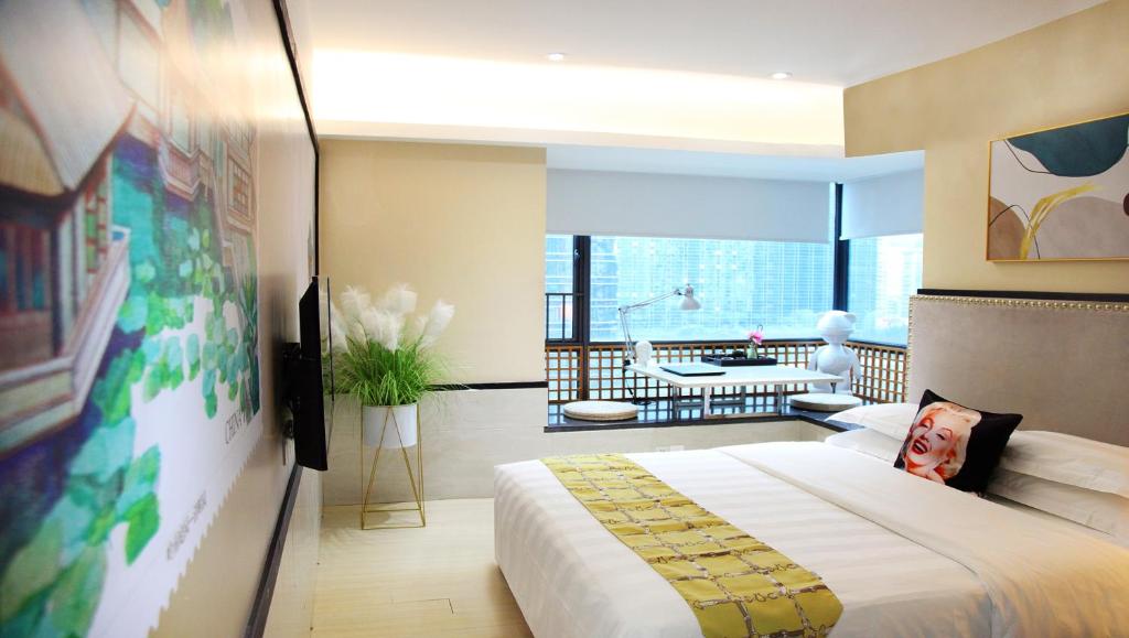 a bedroom with a large bed and a living room at Guangzhou Timmy Hotel in Guangzhou