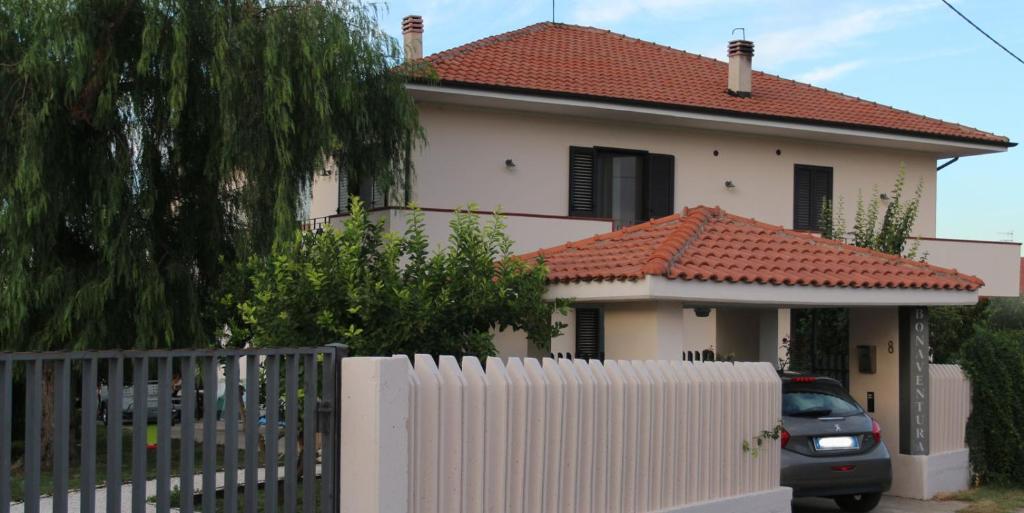 a white house with a fence in front of it at Bonaventura b&b and Bonaventura food in Tollo