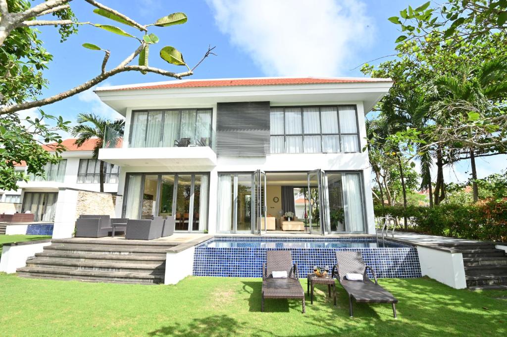 a house with a swimming pool in the yard at Pool Villas at Danang Beach with Private Pool in Danang