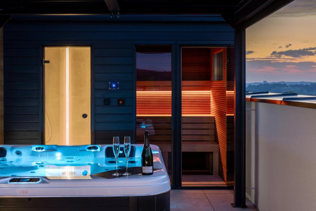 a bathroom with a tub in front of a balcony at Best Apartment SPA in Rzeszów