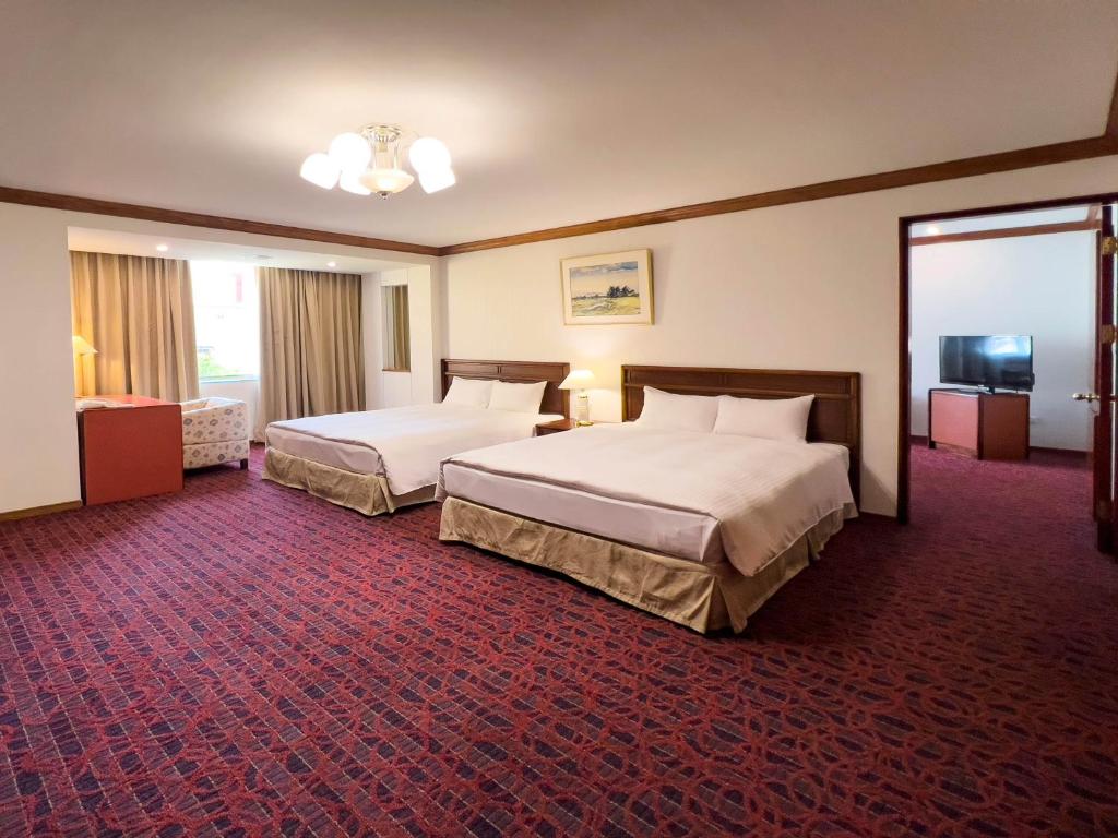 Postel nebo postele na pokoji v ubytování Hotel Tainan