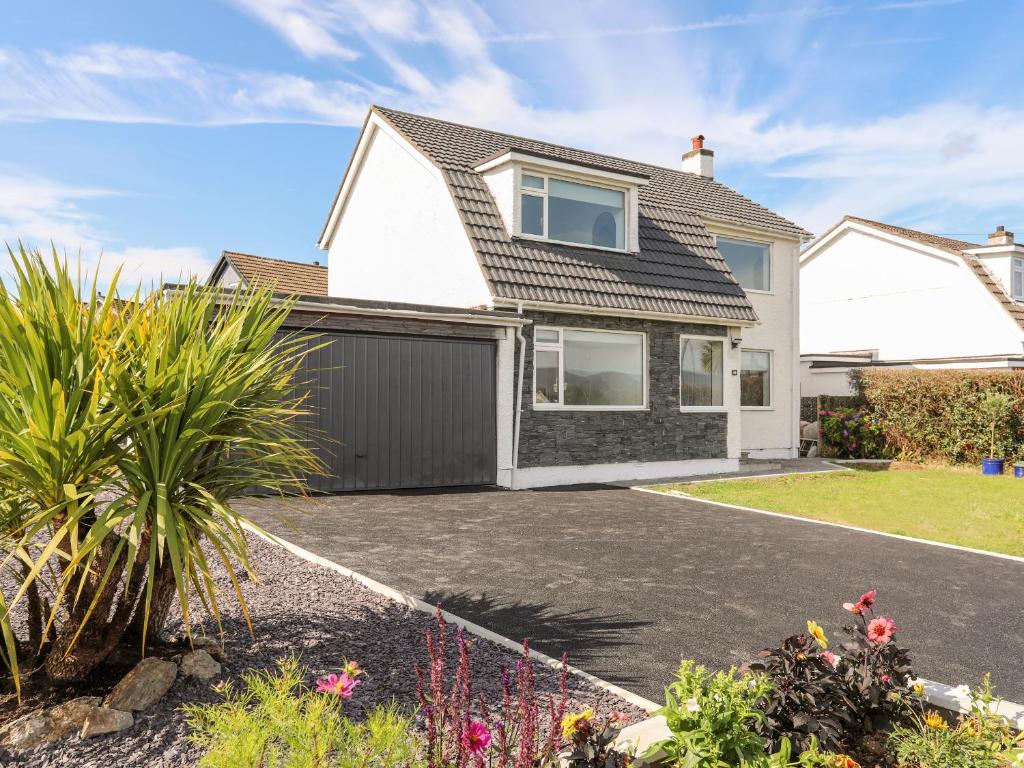 a house with a driveway in front of it at Dolwyn in Menai Bridge