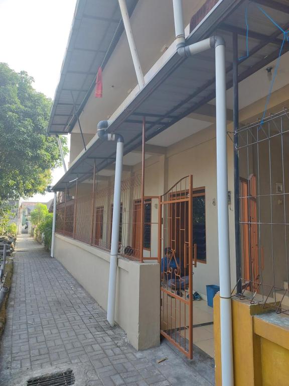 a building with awnings on the side of it at Nusantara kost syariah bulanan harian in Kalasan