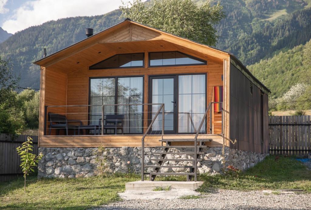 a cabin with a large window on the side of it at Mestia Villas in Mestia