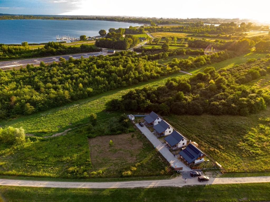 an aerial view of a farm with vehicles parked on a field at Zatoka Perska - Domek Hiszpan - Jezioro Tarnobrzeskie in Tarnobrzeg