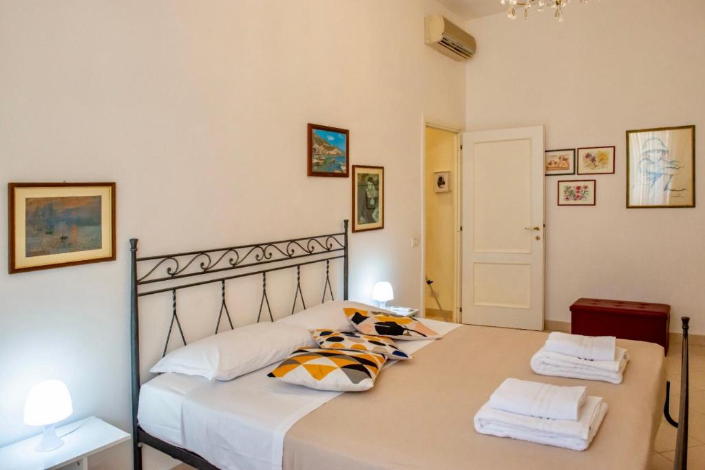 a bedroom with a large bed with two pillows at Alberto Vatican House in Rome