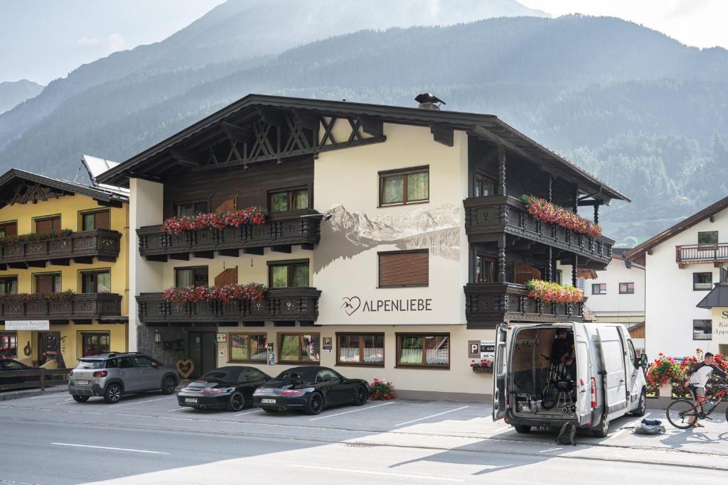 a large building with cars parked in front of it at Alpenliebe in Sölden