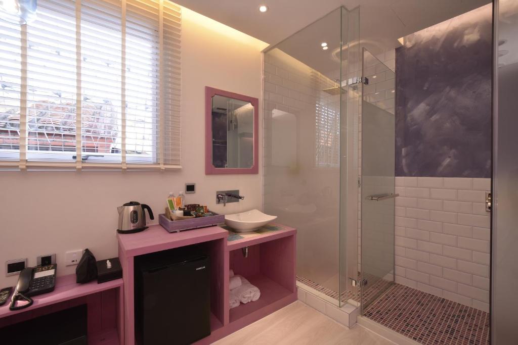 a bathroom with a sink and a shower at DG Hotel in Taipei