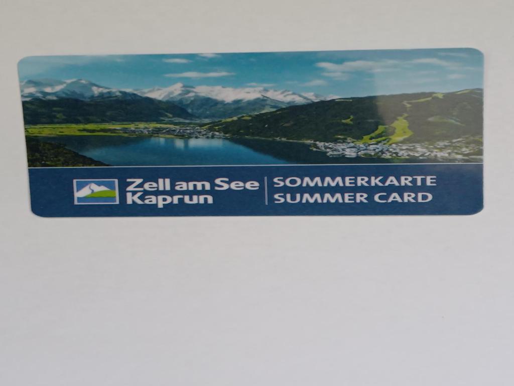 een bord met een foto van een meer en bergen bij Appartement Gschwandtner in Zell am See