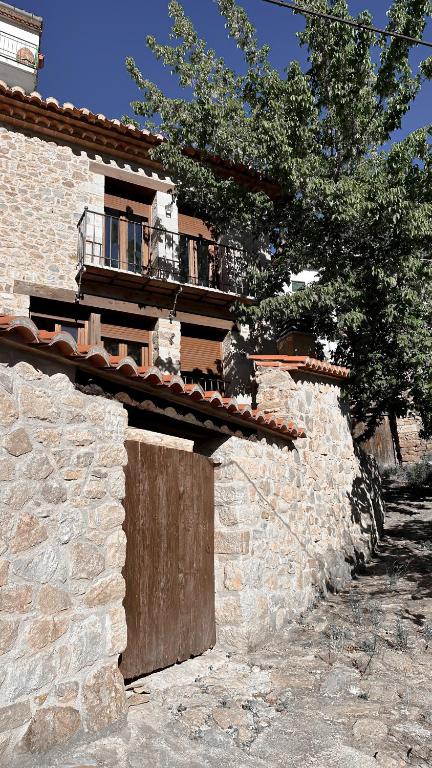 a stone building with a balcony on top of it at La Casa de la Acacia in Olba