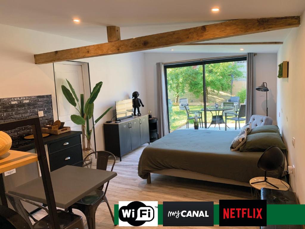 a bedroom with a bed and a sliding glass door at Chambre à la Noye in Estrées-sur-Noye