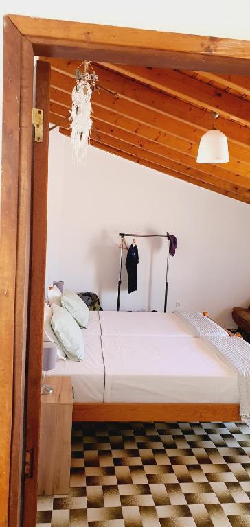 a bedroom with a bed with a wooden ceiling at Casa D'Olívia in Carrapateira
