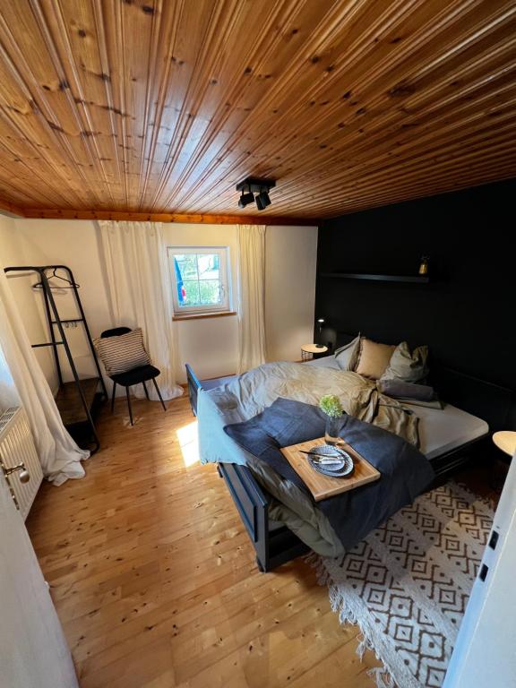 a bedroom with a bed and a wooden ceiling at Tini House in Wagrain