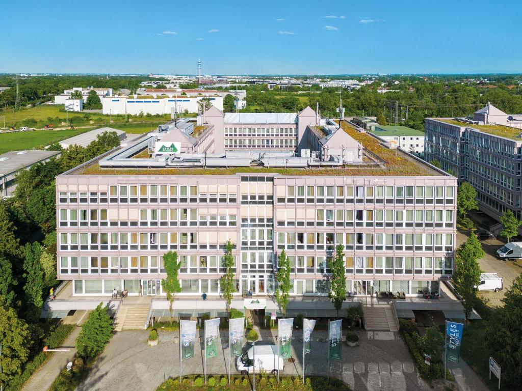 an overhead view of a building with a green roof at Styles Hotel München Messe in Munich