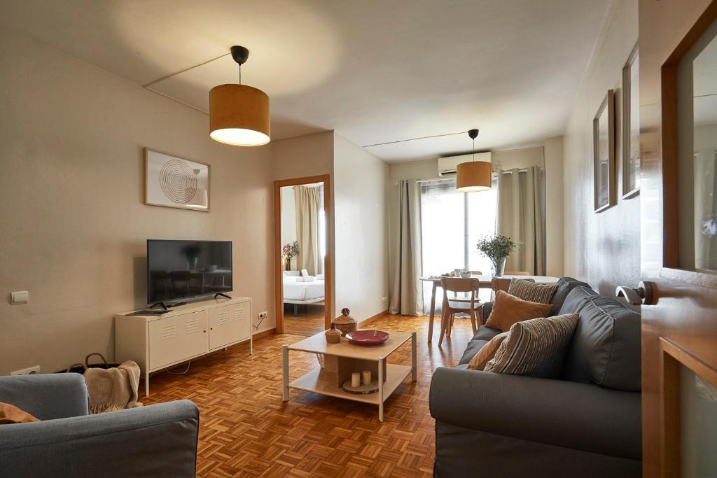 a living room with a couch and a table at BBarcelona Marina Flat in Barcelona