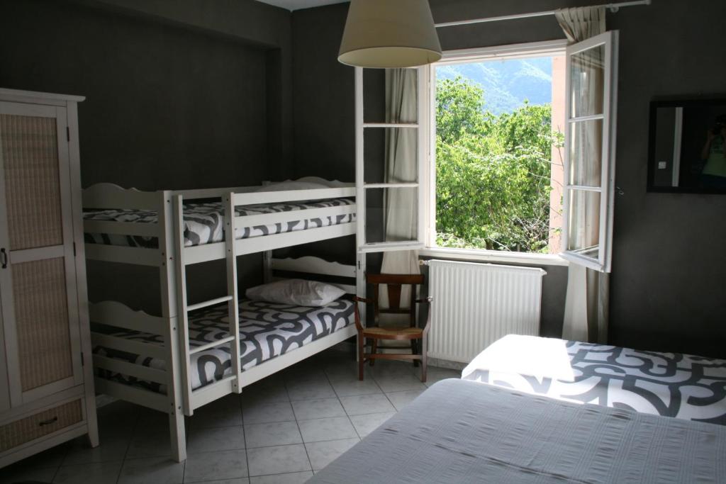 Postel nebo postele na pokoji v ubytování Le Refuge Orezza