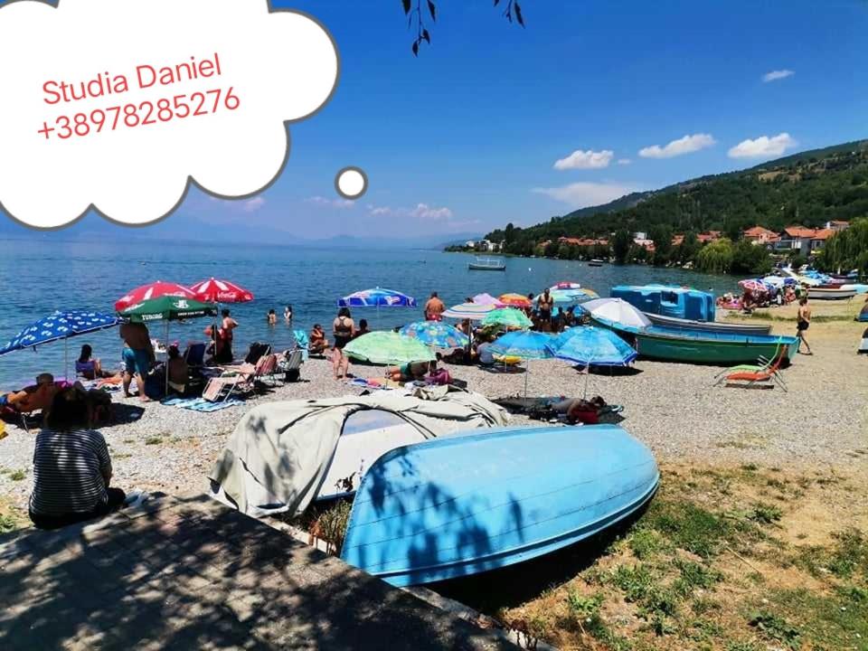 een groep mensen op een strand met parasols bij Studia Daniel in Ohrid