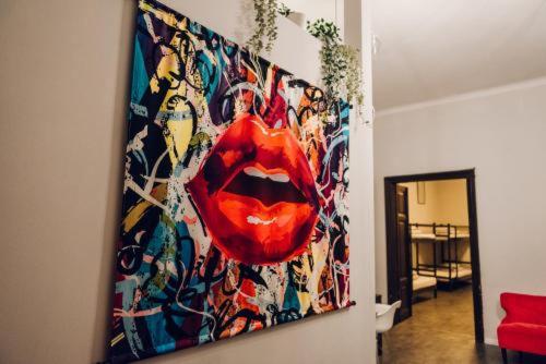 a painting hanging on a wall in a living room at One World Hostel Gdansk in Gdańsk