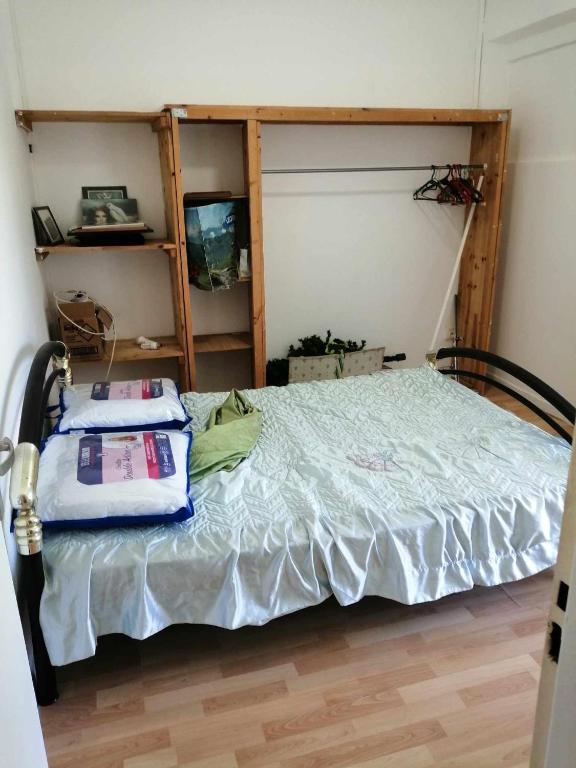 a bedroom with a bed with two pillows on it at Chez Denis et Lucie in Saint-André