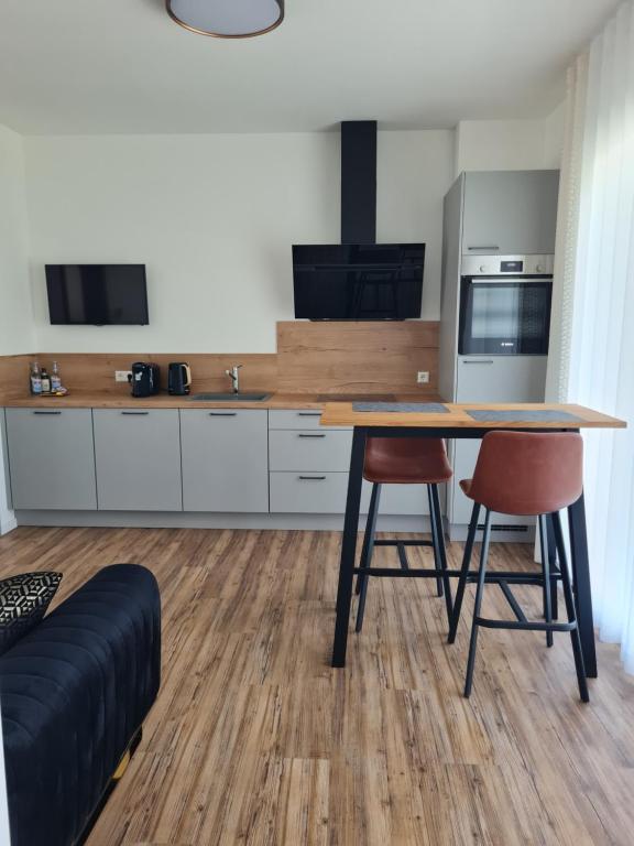 a kitchen with a wooden table and two chairs at Ferienwohnung Wiesflecken in Balingen