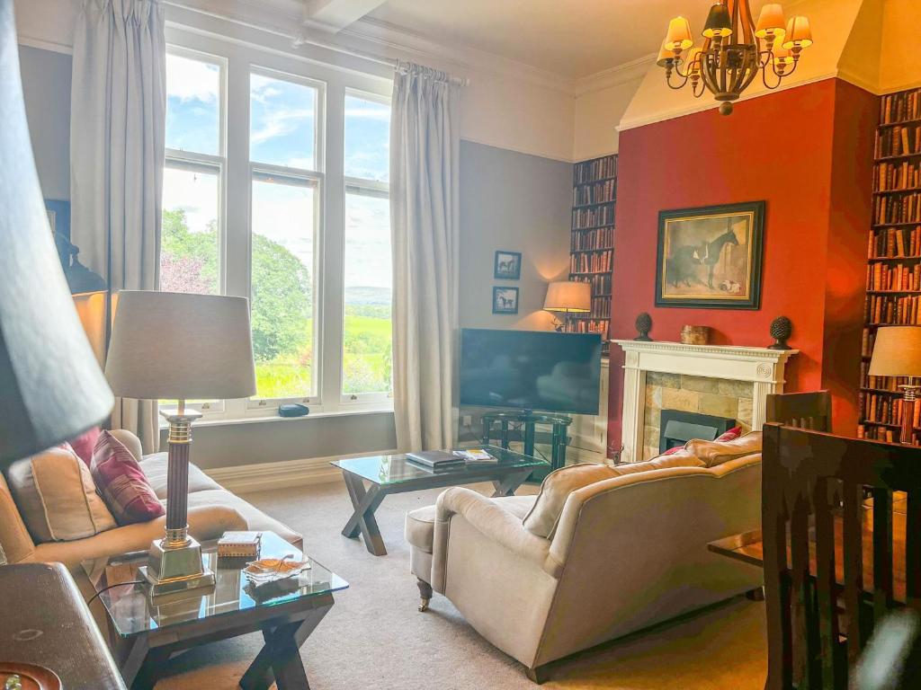 a living room with a couch and a fireplace at Geltsdale Garden Apartment ground floor home in Wetheral close to Carlisle & Ullswater in Wetheral