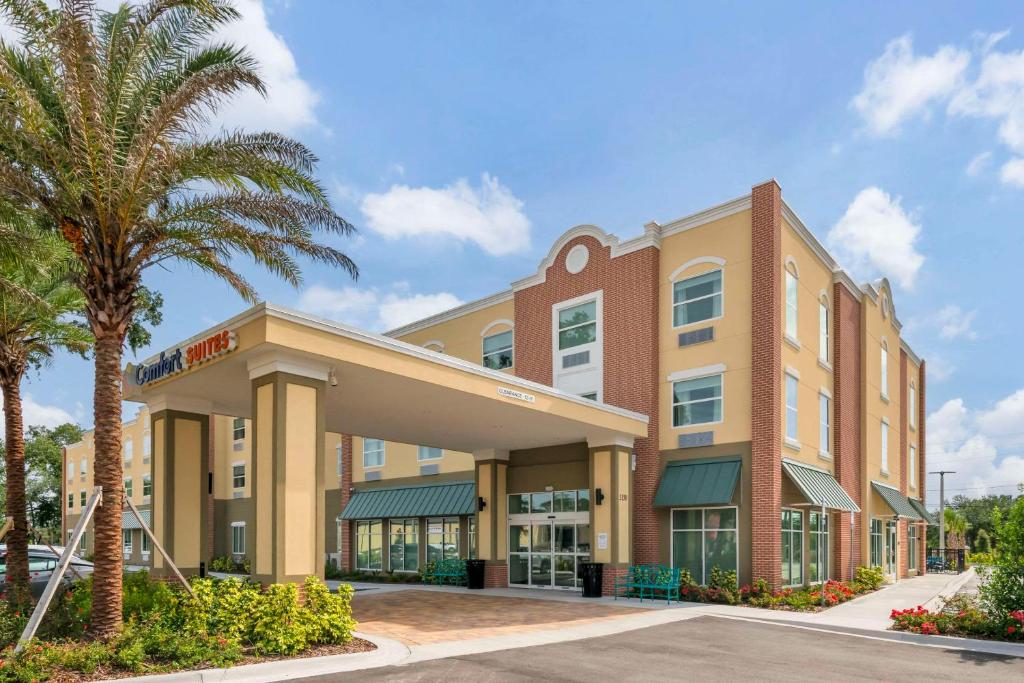 a hotel with a palm tree in front of a building at Comfort Suites St Augustine Historic District Area in Saint Augustine