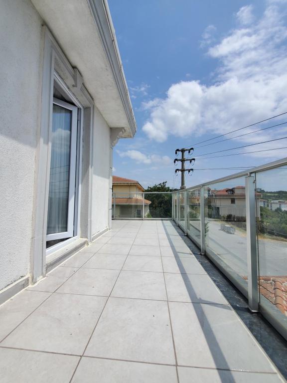 an empty balcony of a white building with a window at Private Room Near İstanbul Airport in Arnavutköy
