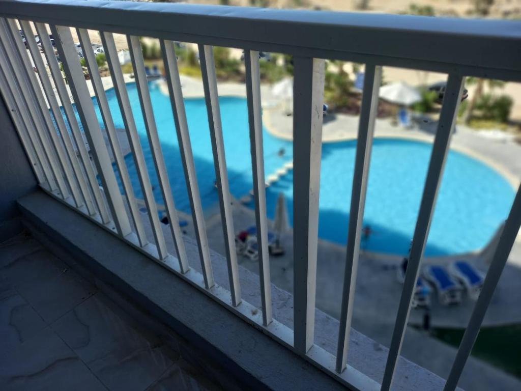 a view of a swimming pool from a balcony at Porto golf marina in El Alamein