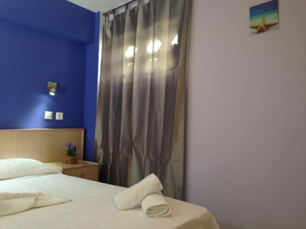 Кровать или кровати в номере Zefyros Hotel