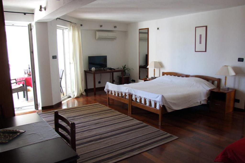 a bedroom with a bed and a television in it at Fox Apartments in Cavtat